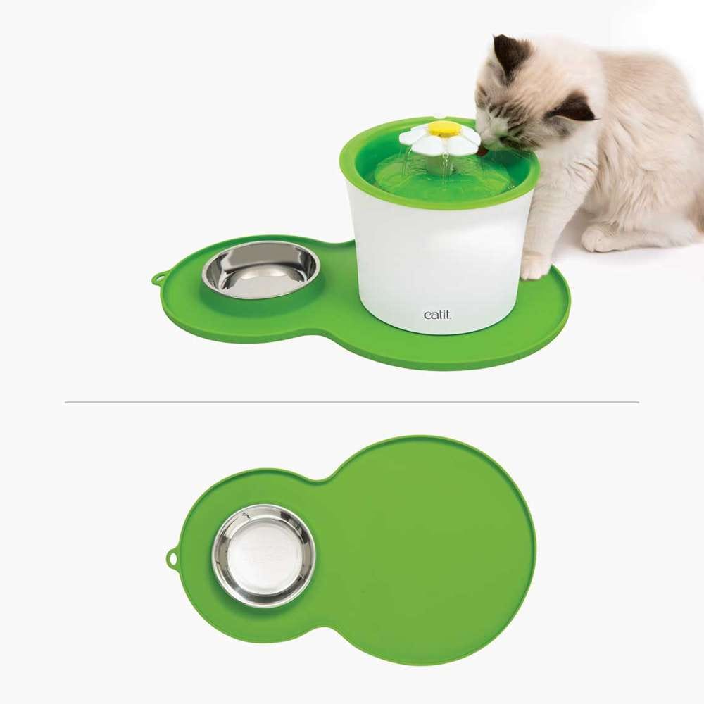 Grüne Catit Erdnuss-Unterlegmatte mit Edelstahlnapf, Katze trinkt daraus komfortabel.